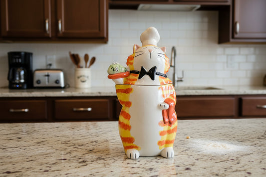 Cat-shaped cookie jar with striped pattern on a white background